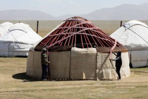 two men are building a yurt